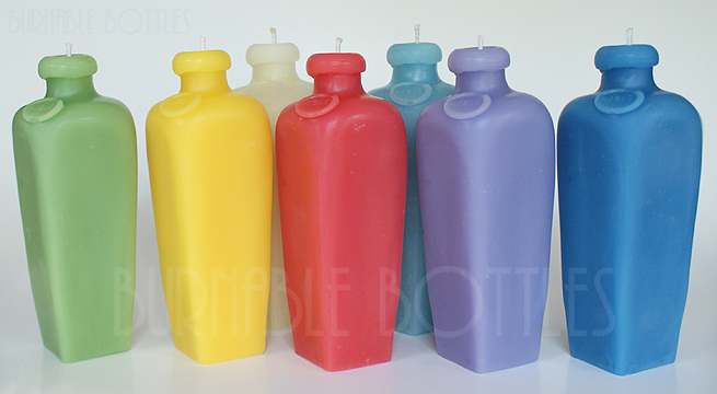 A group of small case gin bottle candles--- Burnable Bottles - AntiqueBottleHunter.com